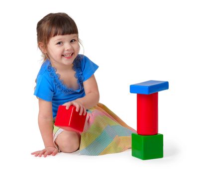 Girl playing with toys on a white background