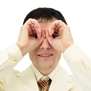 Businessman looking through his fingers like a pair of binoculars