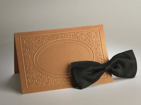 bow tie and the blank card on the plain background