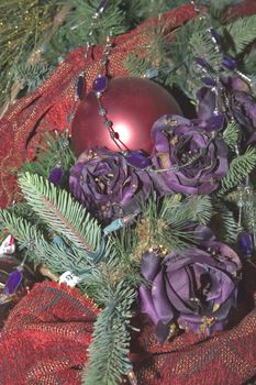 Red and Purple Christmas Tree Ornaments hanging on a Tree.
