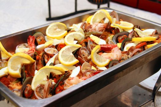 seafood paella served with lots of lemon toppings
