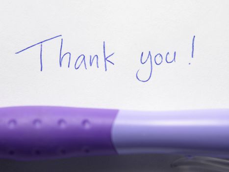 thank you text on the paper with pen