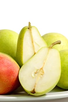 Fresh pears on a plate on bright background