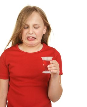 young girl is not happy about taking medicine