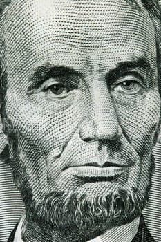 Macro image of a five dollar bill with Benjamin Franklin