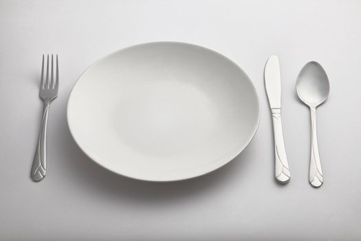 empty kitchen plate with the  fork and spoon