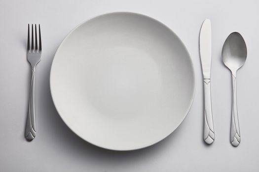 fork and spoon on the side of kitchen plate