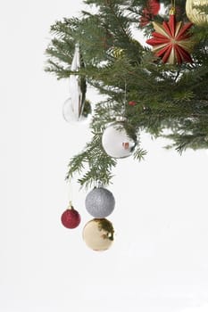 silver, red and gold christmas bulb hanging from the tree