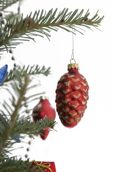 red christmas bulb in the shape of a pine cone hanging from the tree