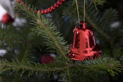 red christmas bell hanging from the tree