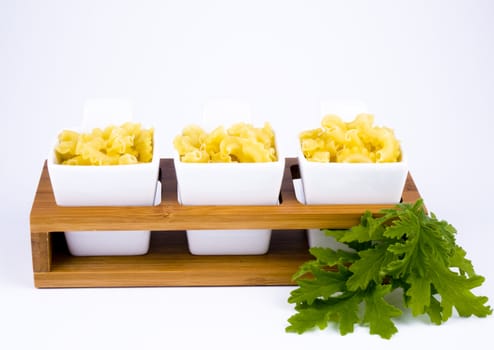 Three porceline bowls filled with pasta 