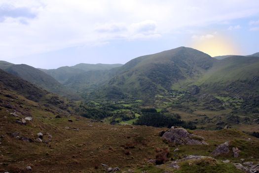 an dawn view of winding roads through the mountains of kerry