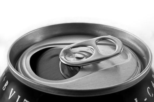 Close and low level capturing an aluminium can ring pull with white background.