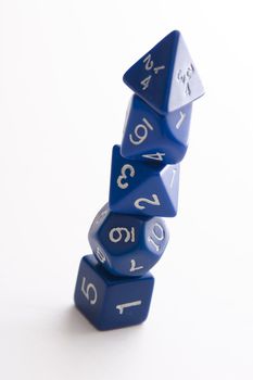 set of blue dice use for role playing games stack up in a pyramid