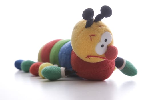Close up view of a plush catapillar with big eyes