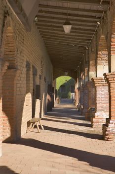 MISSION SAN JUAN CAPISTRANO WITH LIGHT AND SHADOWS STREAMING THROUGH.