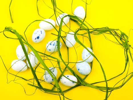 White easter eggs on yellow background.