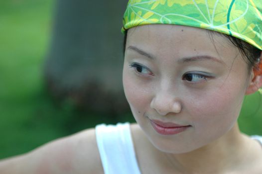 Chinese girl - close portrait with green scarf on head.