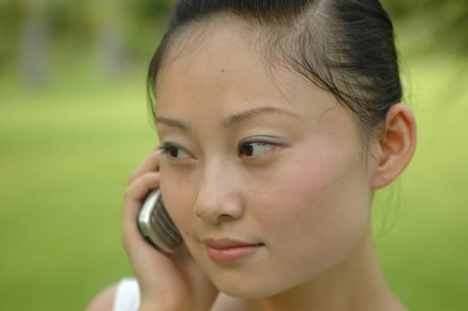 Chinese girl using mobile phone, calling.