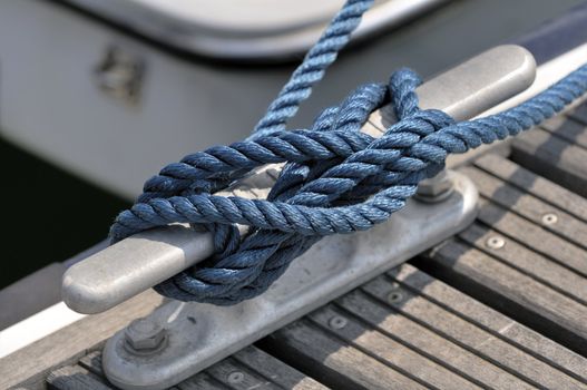 Close-up of a jetty bitt with tied up rope
