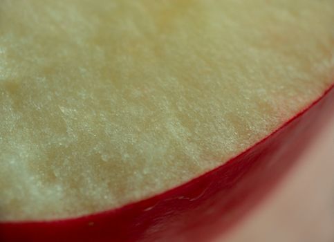 macro pattern of apple slice with red surface