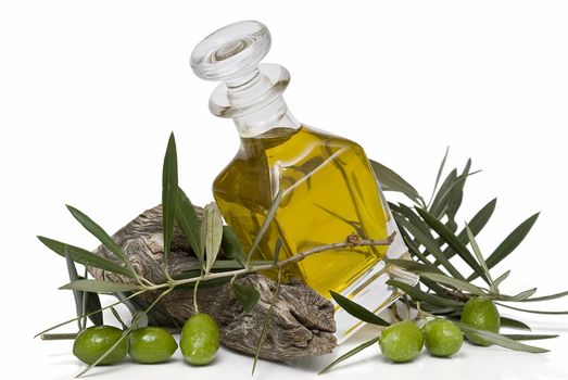 Olive oil bottle witn olives and olive branches isolated on white background.