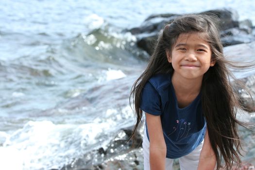 Child playing by lakeshore