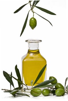 Olive oil bottle witn olives and olive branches isolated on white background.