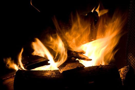 Flames of Fire in a Fireplace against a black Background 