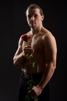 standing romantic man with red rose
