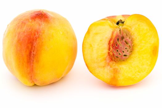 Two ripe peaches on a white background