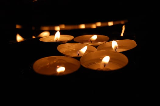 lights of candles isolated on the black background