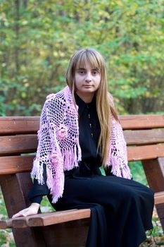 Portrait of the beautiful girl in autumn forest. 
