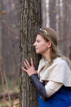 Portrait of the romantic girl in autumn forest
