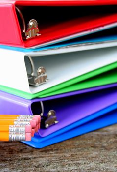 School or business supplies.  4 binders and pencils, used a shallow DOF with focus on the erasers.  