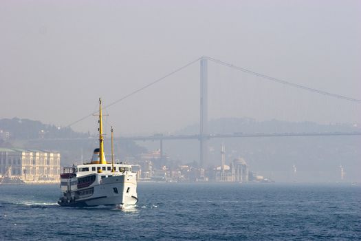 Passenger ferry sails between two continents, Europe and Asia in Bosporus Strait, Istanbul, Turkey. Foggy day