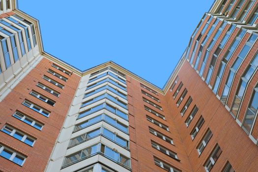 A residential multistory house and sky, view from below