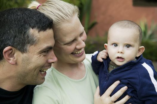 Bolnde woman and hispanic man with their cute baby boy