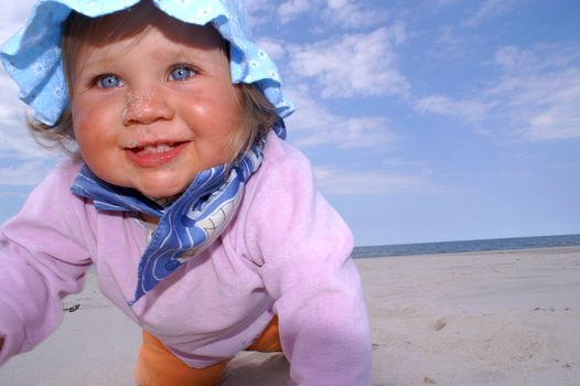 baby smile and crawl on the beach