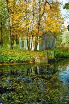 Ancient cottage and quay in the autumn park