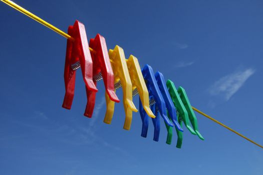 Pegs on washing clothes laundry line, blue sky