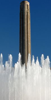 The World War I Memorial Monument behind a water fountain.
