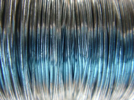 A close up photo of fine silver craft wire on a spool.