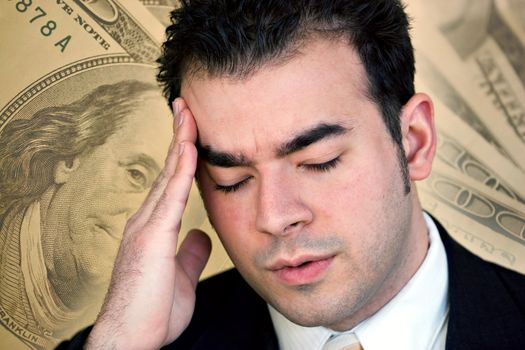 A man with a headache from all of the stress of his financial problems.