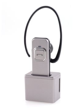 Bluetooth headset in a loader  isolated on a white background.