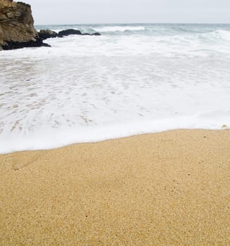 Waves coming in during the morning, when it is cold and foggy.