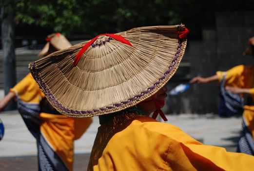 Japanese woman in traditional costume, wears a straw hat and yukata kimono center of image