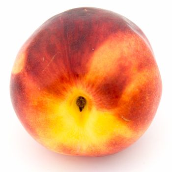 One ripe nectarine on a white background