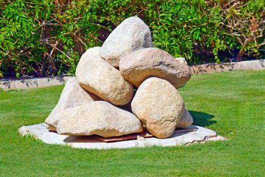 Large, decorative stones stacked in a pile in the garden.