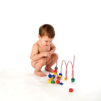 Boy playing with multicolored cubes and curl isolated on white